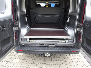 Offener Transporter mit Schubladenfach auf Pflaster.