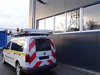 Nutzfahrzeug vor einem Werkstattgebäude geparkt.