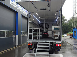 Ein geöffneter LKW-Anhänger mit Treppe und Innenausstattung.